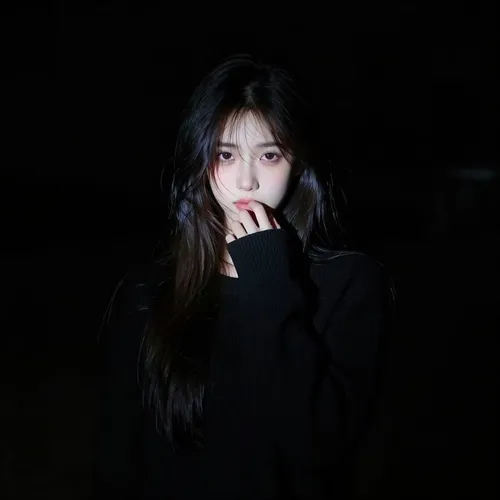 A hyperrealistic portrait of an American female character emerges from a pure black background. A narrow, sharp beam of light falls only on the very center of her face, creating a dramatic spotlight effect. The edges of the light are crisp and hard, with no soft diffusion. Everything outside the spotlight vanishes quickly into deep, velvety shadows—almost indistinguishable from the darkness behind her.

Her long dark hair frames her face, with a few loose strands falling across it. The lower part of her hair fades into the surrounding blackness. She wears a black long-sleeve knit sweater, which disappears almost entirely into the shadow, leaving only the suggestion of her form.

Her expression is shy and mysterious. One hand is raised gently to her lips in a hesitant gesture, while her eyes look directly at the viewer. The lighting creates extreme contrast—only the face within the spotlight is sharp and defined, with the rest of the scene falling away into near invisibility. The overall tone is dark, moody, and intensely dramatic, captured with a realistic-anime art style.